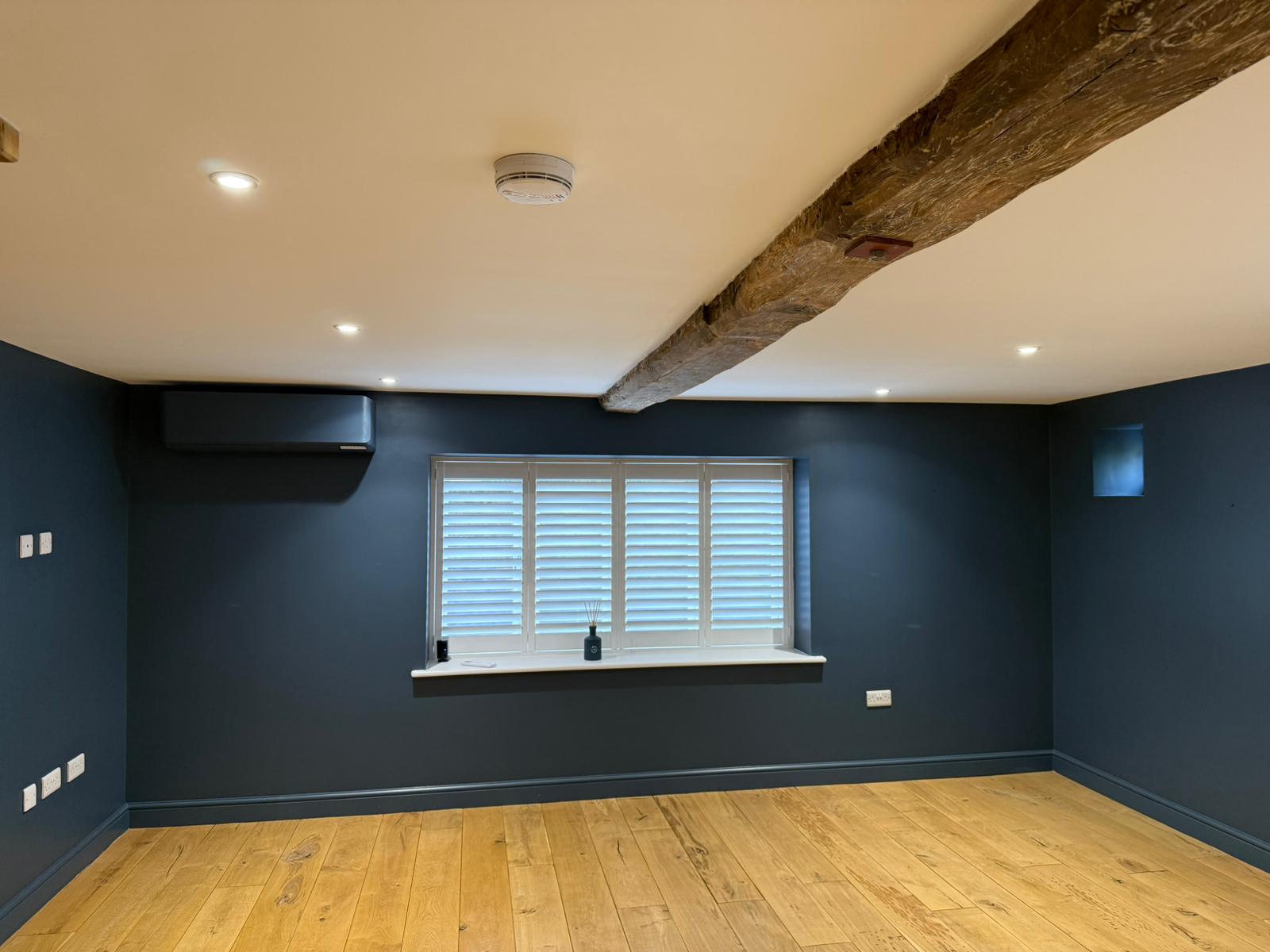 Navy feature room with exposed beam